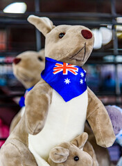 A kangaroo stuffed toy is wearing an Australian Flag bandanna and is for sale on a market stall.