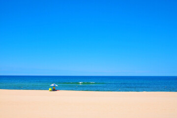 Fototapeta na wymiar A summer scene where a security guard sits alone looking at the sea.
