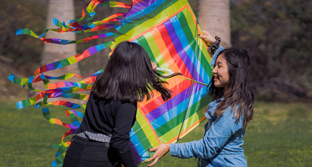 Girls playing with kite in a para