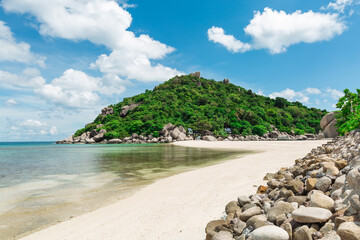 beach with a mountain and white sand