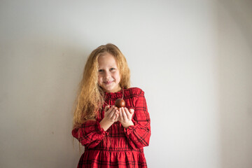 girl in a red dress with easter eggs, selective focus