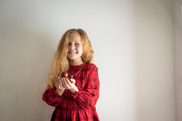 Fototapeta premium girl in a red dress with easter eggs, selective focus