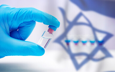 Close up on vaccine and medical syringe, Israel flag in the background