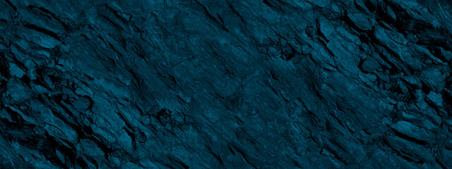Blue green stone background. Dark blue toned monochrome rock texture. Close-up. Wide banner....