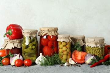 Different canned food and ingredients on gray table