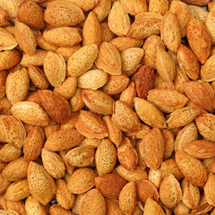 Pile of almonds close-up as background.