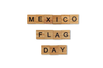 Top view of the word mexico flag day laid out from square wooden tiles isolated on blue background. World and international day.