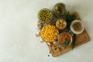 Different pickled food and ingredients on white textured background