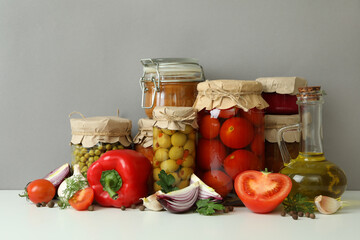 Different pickled food and ingredients against gray background
