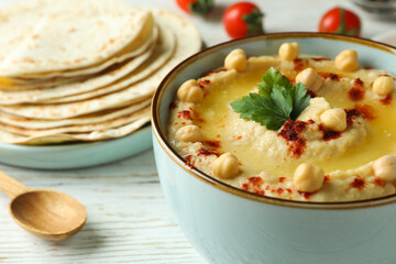 Concept of cooking hummus on white wooden background