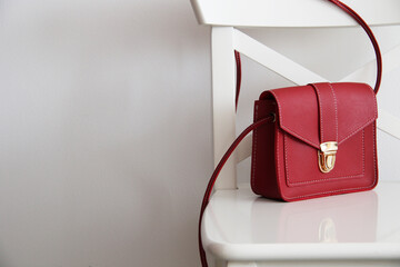 small red women bag on white chair