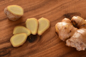 Sliced ​​ginger on wooden board.