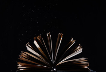 Vintage open Book Glows In The Darkness. Concept of self-education, knowledge and intellect 
