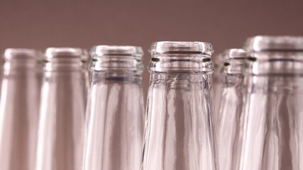 Tops Of Empty Transparent Glass Bottles Standing In A Row