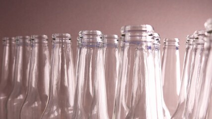 Tops Of Empty Transparent Glass Bottles Standing In A Row