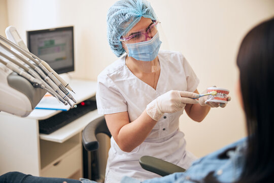 Professional Dentist Showing The Way Of Teeth Care