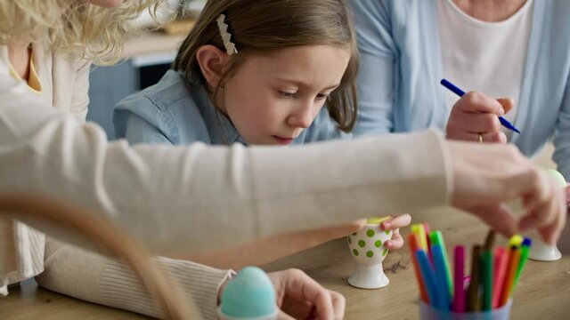 Video of three generations of women coloring Easter eggs. Shot with RED helium camera in 8K.