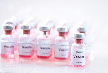 Different types of Covid vaccine bottles medical background