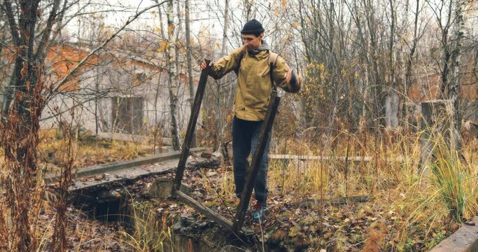 a traveler in an abandoned city looking for firewood