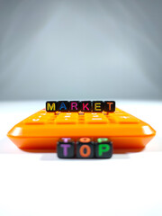Selective focus.Word MARKET from block dice with calculator on a white background.Business concept...