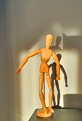 wooden mannequin on the table