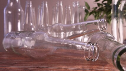 Empty Transparent Glass Bottles Rolling On A Wooden Table 