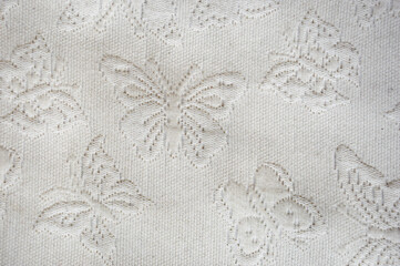 the texture of the fabric. butterflies on a white bedspread. background for the design.