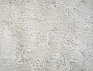 the texture of the fabric. butterflies on a white bedspread. background for the design.