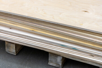 Sheets of thick plywood in a stack at a hardware store. Natural wood material for construction and furniture making