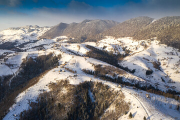 Aerial scenic rural view over Pestera village at the bottom of Piatra-Craiului Mountains during a...