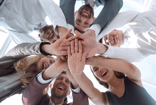 close up. a group of young business people showing their unity.