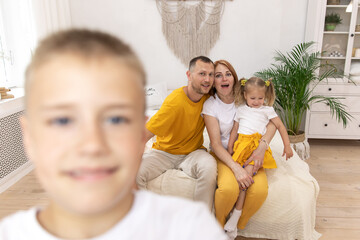 boy takes selfies with family