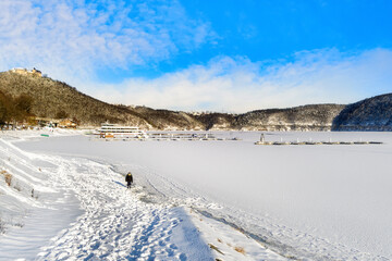 Beautiful snowy landscape with excurision ship at the Edersee in winter.
