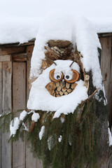 Decorative wooden owl and winter nature in Russia. Snow, snowy russian winter. Rural house. Rural...