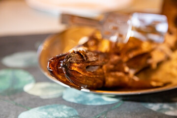 delicious smoked fish on a plate. close-up, selective focus, blurred background