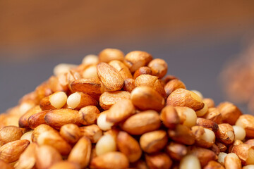 A heap in the form of a slide of pine nuts from Siberia, peeled from the shell, close-up.