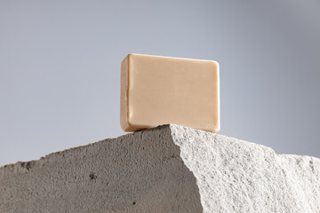 Soap bar on gray cinder block close up