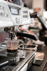 black coffee in measuring cup put on coffee maker