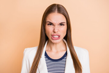 Photo of angry young lady frowning look camera wear white jacket isolated pastel beige color background