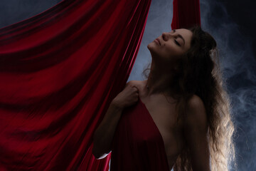 Gorgeous nude woman with red color silk. Concept of Sexuality and sensitivity