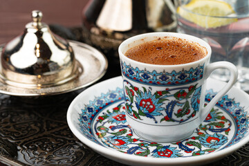 Cup of coffee in oriental style on metal tray