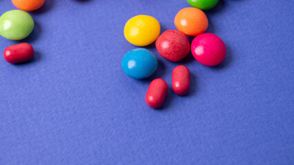 colorful little candies on a colored background