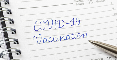 COVID-19 Vaccination written on a calendar page