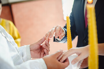 Religious marriage in the Orthodox church. Wedding matrimony. Exchanging wedding rings. Priest...