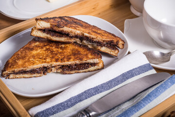 French toast cut into triangles on a plate in a breakfast tray close-up
