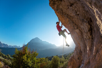 climber overcomes a difficult route