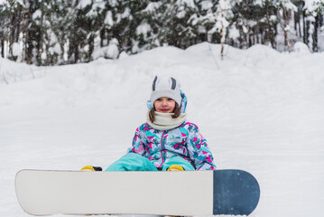 Little girl snowboarder