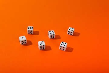 group of several dice on orange background 
