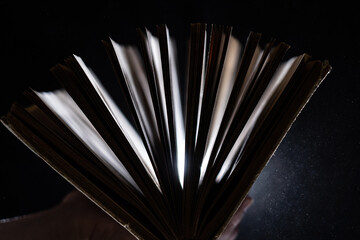 Vintage open Book Glows In The Darkness. Concept of wisdom and knowledge