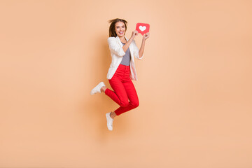 Full length photo of girl jump presenting like paper card wear white jacket trousers sneakers...